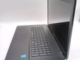 a laptop with a blue sticker on it sitting on a table