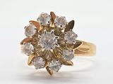 an image of a gold ring with a cluster of white diamonds