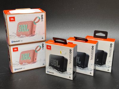 three boxes of jbl go portable speaker sitting next to each other