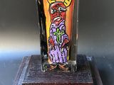 a glass vase with a painting of a man on it