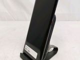 a cell phone that is on a stand on a table