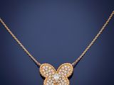 a diamond butterfly pendant on a gold chain