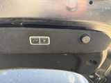 a close up of a car ' s door handle with a button on it