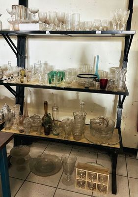 a shelf with many glasses on it in a room