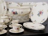 many plates, cups, and saucers on a table