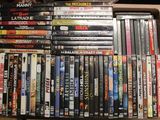 a lot of dvd ' s stacked on top of each other