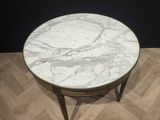 an image of a marble top coffee table on a chevroned wood floor