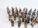 a lot of figurines that are on a white surface