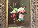 painting of a vase of flowers in a gold frame on a blue wall