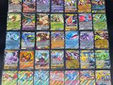 a close up of a bunch of pokemon cards sitting on top of a table