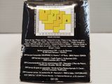 a box of yellow and white tiles on a white table