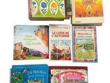 several children ' s books sitting on top of each other on a white surface