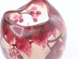 a close up of a vase with a cat on it