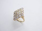 a close up of a gold ring with diamonds on a white surface