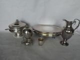 three pieces of silverware on a table with a white background