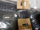 a pile of black plastic bags and a box on the ground