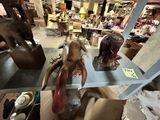 two statues of elephants on a shelf in a store