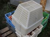 a plastic crate sitting on top of a pallet in the grass