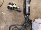 an image of a corded sander sitting on the ground next to other tools