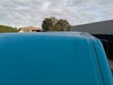 an image of a blue truck parked in a parking lot