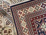 a close up of an oriental rug with fringes on top of it