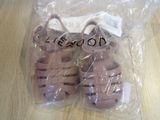a pair of sandals in a plastic bag on a table
