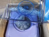 a purple blender sitting inside of a box on a table
