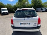 a small white car parked in a parking lot