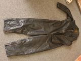 a pair of black leather pants laying on the floor