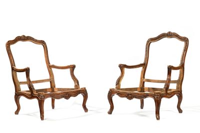 pair of carved wood armchairs with arms and legs