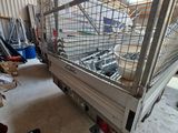 a truck that has a cage on the back of it