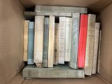 une boîte remplie de livres posés sur une étagère