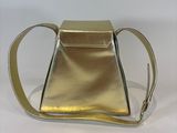 the small gold purse is sitting on a white surface