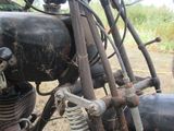 a close up of a motorcycle parked in a field