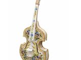 a close up of a violin shaped figurine on a white background