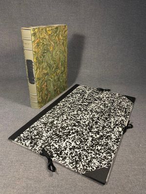 two books are sitting on a table next to each other