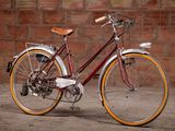 a bike that is parked in front of a brick wall