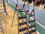 many ladders that are lined up in a warehouse