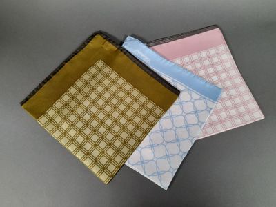 three different colored napkins sitting next to each other on top of a table