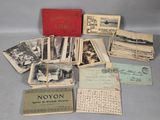several old postcards are stacked on top of each other on a table