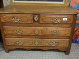 a picture of a dresser in a room with a painting on the wall