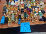 many bottles of perfume on a table with a price tag