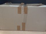 a cardboard box sitting on top of a wooden table