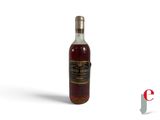 a bottle of whiskey sitting on top of a white surface