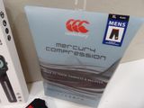 a box of men ' s compressions and a watch on a table