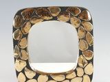 a close up of a square shaped mirror with rocks on it