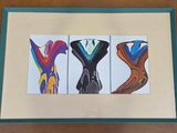painting of three different types of shoes in a frame on a table