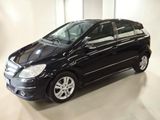 a picture of a black car that is parked in a garage