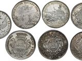 a group of six silver coins sitting on top of each other