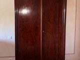 a large wooden cabinet in the corner of a room